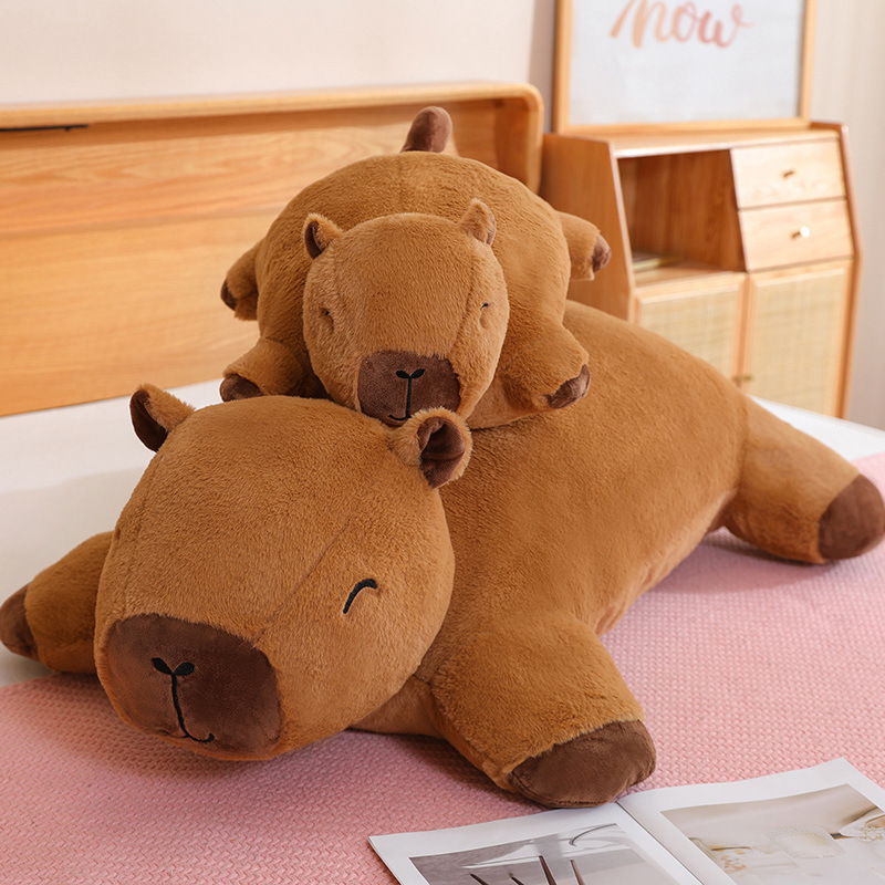Capybara plush cushion stacked on bed, soft hugging pillow for relaxing and cozy bedroom decor