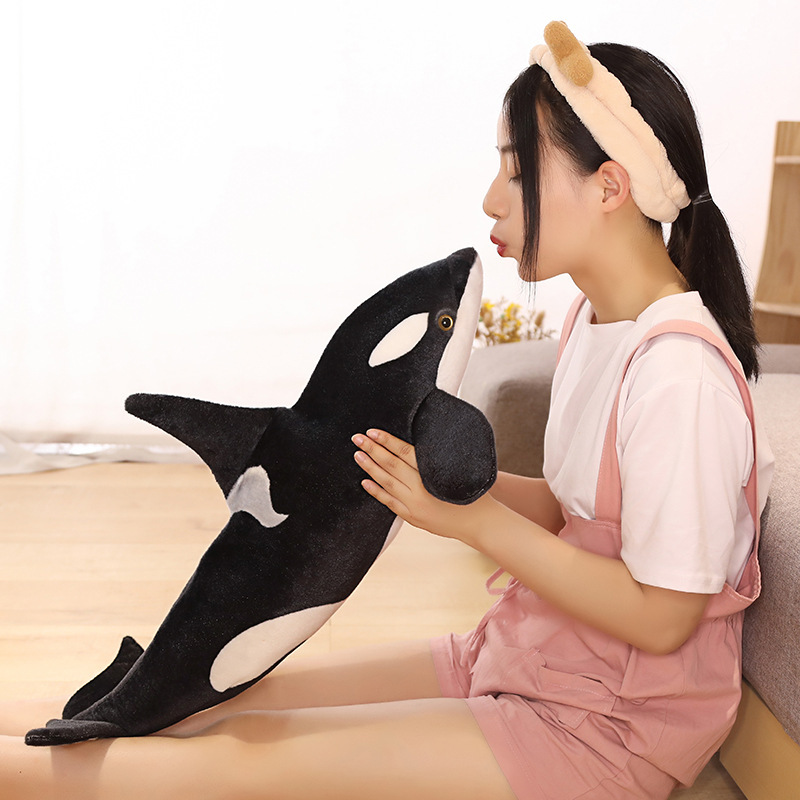 Orca killer whale long plush pillow held upright for hugging and comforting playtime