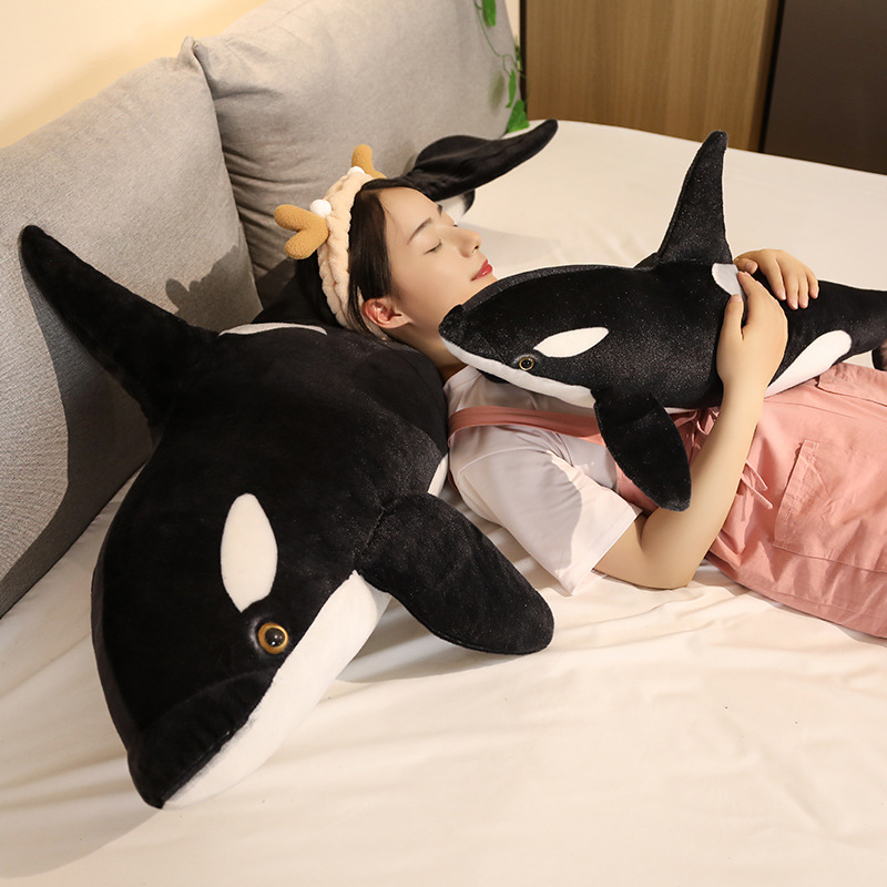 Orca killer whale long plush pillow used for hugging and relaxing on bed