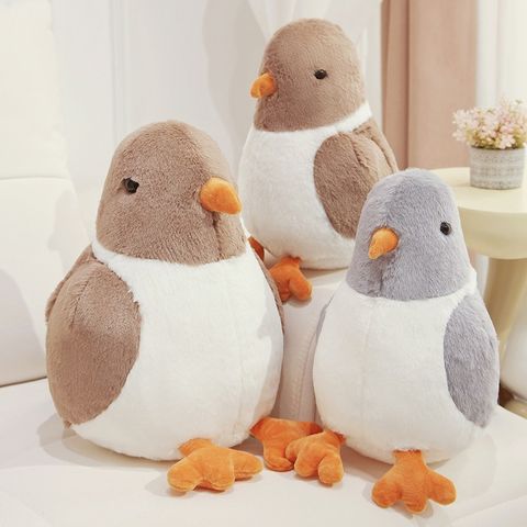 Cute pigeon plush toys in gray and brown colors arranged for decorative and relaxing home setting