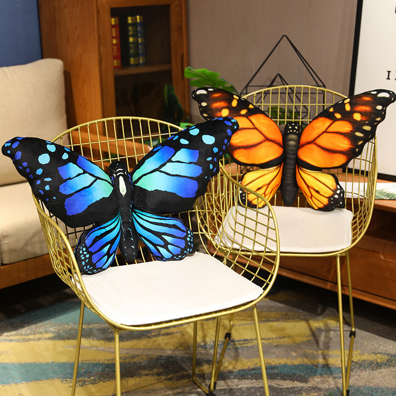 Large butterfly plush pillows styled on chairs for modern living room decor and comfort