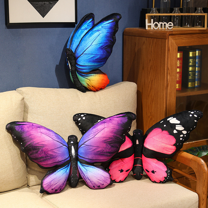 Realistic butterfly plush pillows displayed on a sofa for colorful home decor
