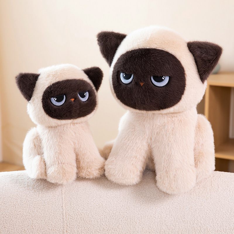 Sitting ragdoll cat plush toy in two sizes on a sofa