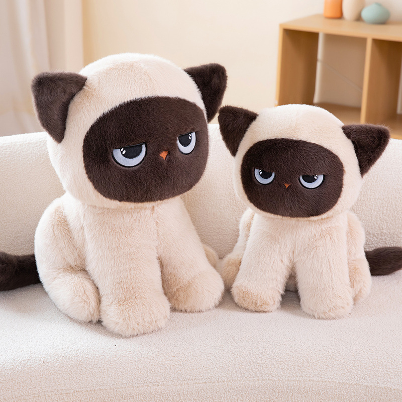 Cute sitting ragdoll cat plush toy pair relaxing on couch