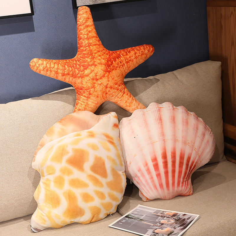 Realistic conch shell, scallop, and starfish plush pillows arranged on a sofa, soft ocean inspired cushions for cozy lounging and coastal style home decor