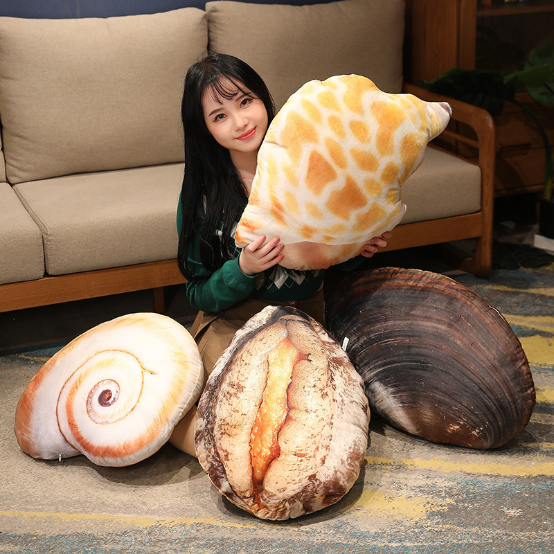 Realistic seashell plush pillow assortment arranged on floor and sofa, soft ocean themed cushions for cozy home decor