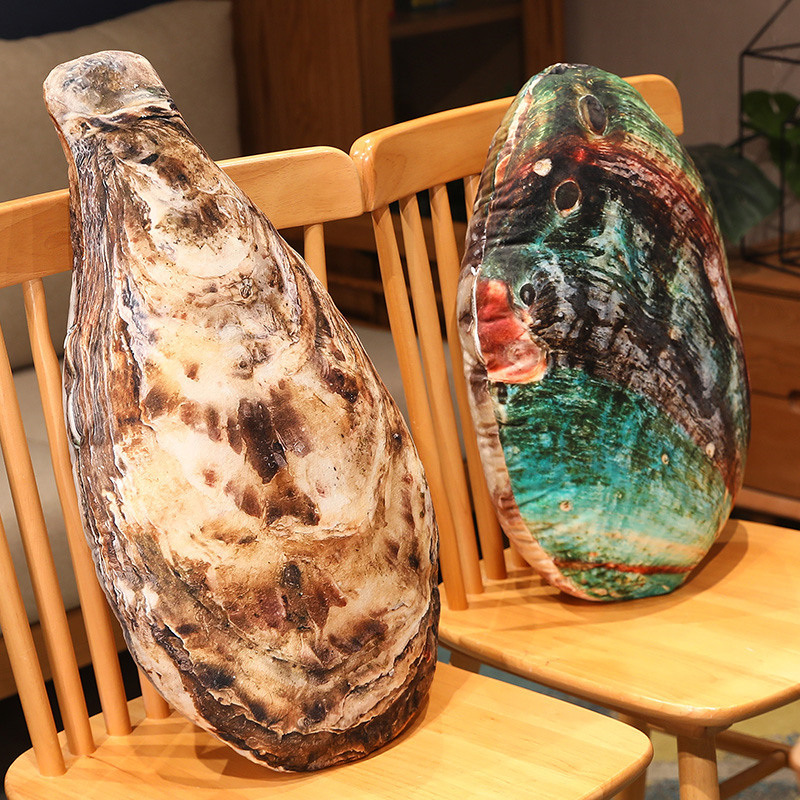 Realistic oyster and abalone plush pillows displayed on wooden chairs, ocean-inspired decorative cushions for sofa, bedroom, or cozy home styling