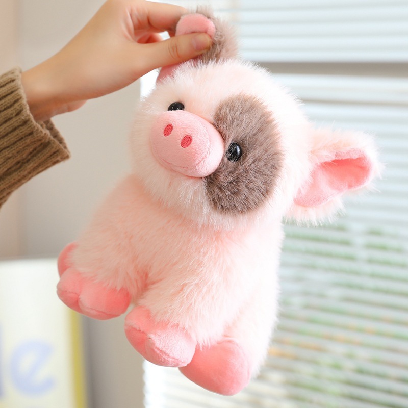 Cute mini pig plush toy being gently lifted, showing soft plush fabric and fluffy texture, perfect for cozy home decor and gifting