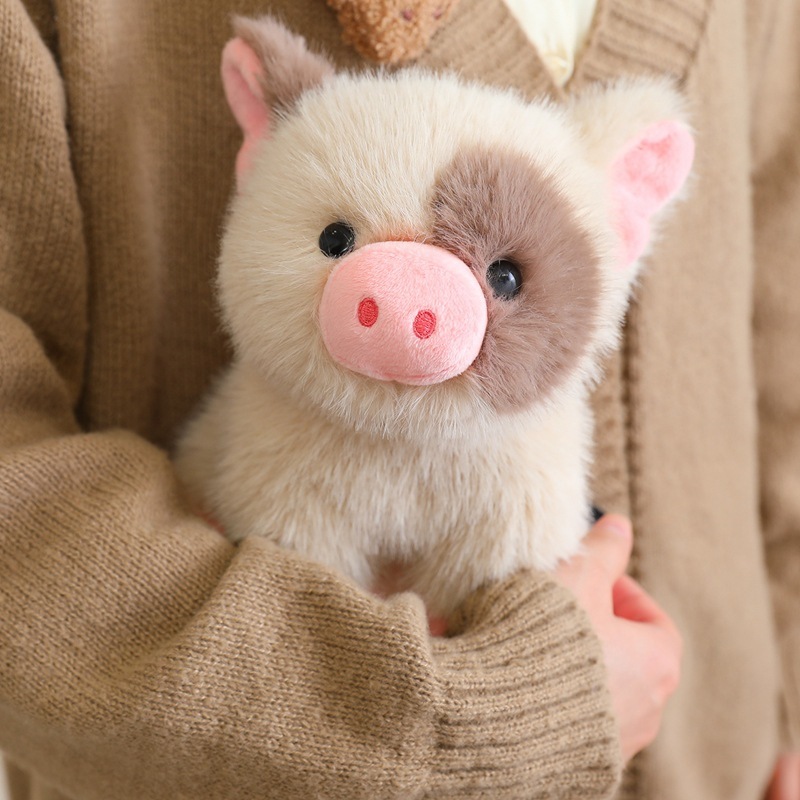 Close up of cute mini pig plush toy, fluffy plush texture with pink nose, soft comforting toy for cozy home use
