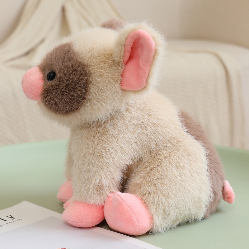 Cute mini pig plush toy shown from side angle, soft plush fabric with pink details, sitting on table for cozy home decor and gentle hugging display