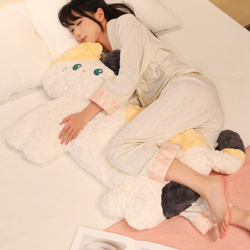 Fluffy cat plush pillow on bed, soft hugging body pillow for sleeping and cozy nighttime comfort