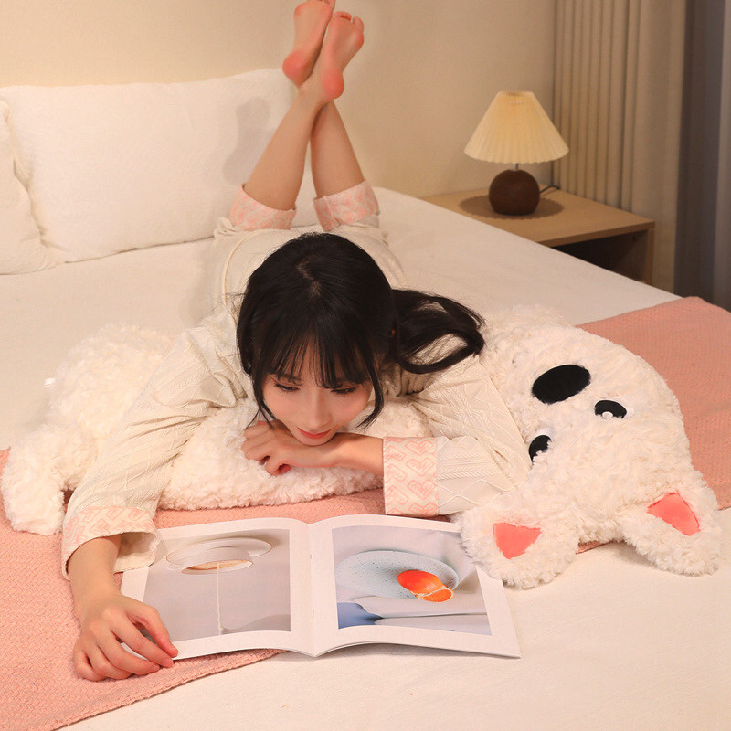 Soft fluffy animal plush pillow placed on a bed for hugging and lounging, adding a cozy and calm bedroom atmosphere perfect for relaxing and quiet reading time