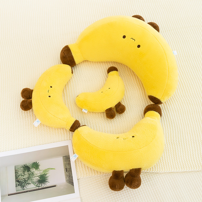 Banana plush toy with legs in multiple sizes arranged on a soft bed surface, highlighting the cute design, plush texture, and suitability for cuddling, decor, and relaxing use