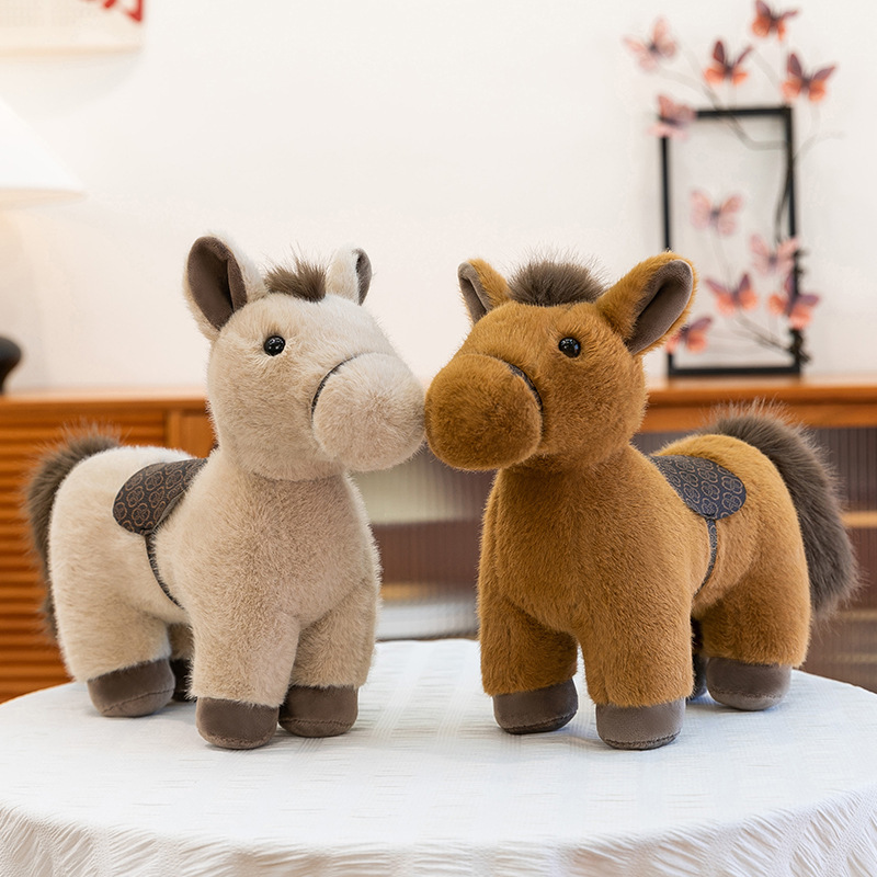 Pair of realistic pony plush toys in brown and khaki colors with detailed saddle design, standing together in a cozy indoor setting, highlighting soft texture and balanced shape, ideal for home decor, gifting, or comforting plush collection display
