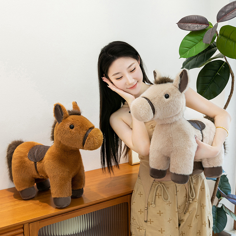 Realistic pony plush toy with saddle placed in a cozy indoor setting, showing soft texture, sturdy standing shape, and comforting size, ideal for cuddling, relaxation, and warm home decor