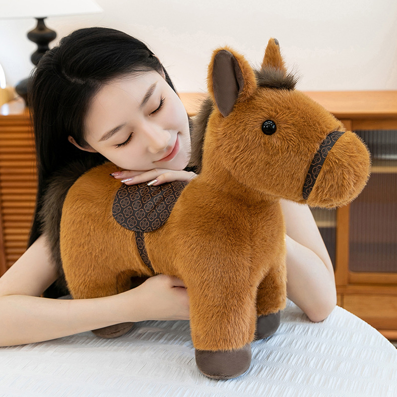Soft realistic pony plush toy with saddle placed on a table, highlighting its fluffy texture and comforting size, perfect for cuddling, relaxing moments, or as a cozy decorative plush at home