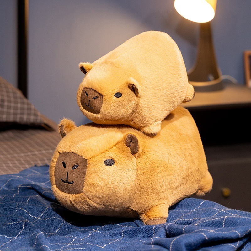 Capybara plush toy stacked on a bed, soft and cozy stuffed animal for home decor