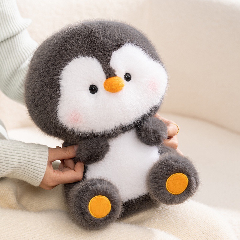 Coco penguin plush toy with soft fluffy texture, perfect for hugging and relaxing on a cozy sofa, bringing warmth and comfort to everyday home moments