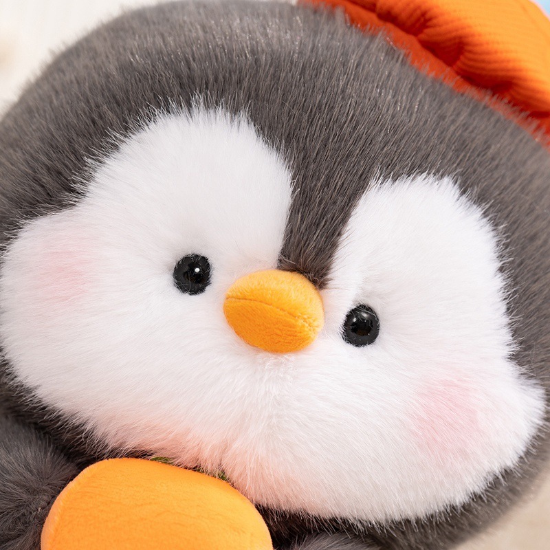 Close-up of coco penguin plush toy face, ultra-soft plush fabric with gentle expression, designed to bring a calming and cozy feel for everyday comfort and decorative display