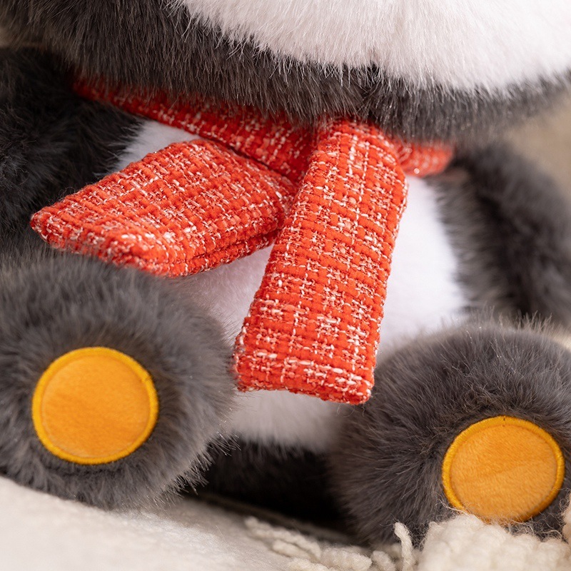 Close-up of coco penguin plush toy scarf detail, soft textured fabric and fluffy finish, highlighting cozy craftsmanship and warm winter-style design for comforting hugs and home decor