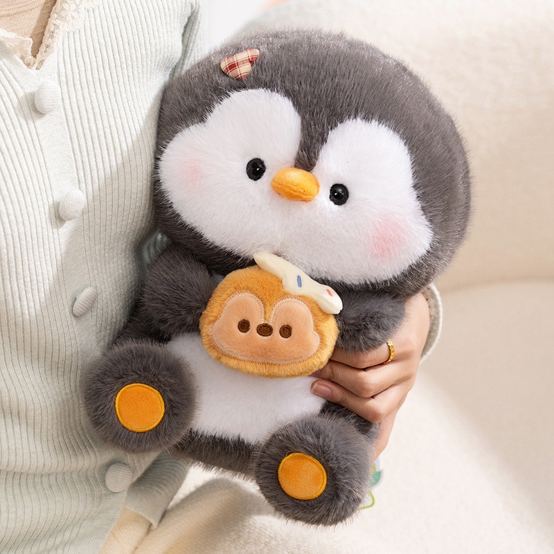 Coco penguin plush toy holding dessert accessory, soft plush fabric with rounded shape, ideal for hugging and relaxing, cozy home decor plush with warm and comforting vibe