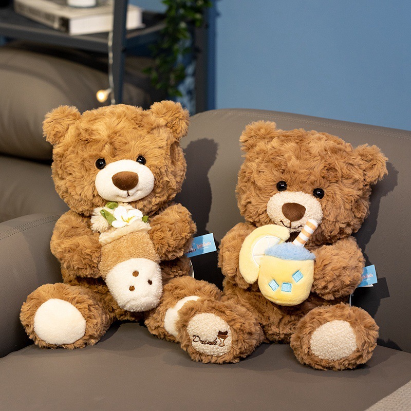 Milk tea bear plush toys in pearl and lemon designs displayed on a sofa, perfect for hugging or home decor