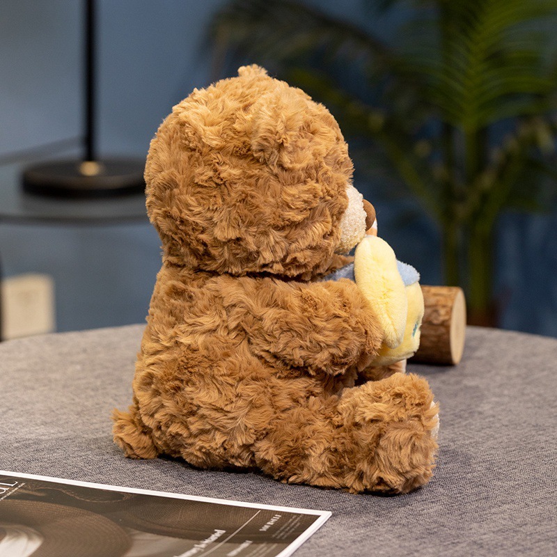 Lemon milk tea bear plush toy shown from the back, highlighting its fluffy texture and seated design in a cozy home setting