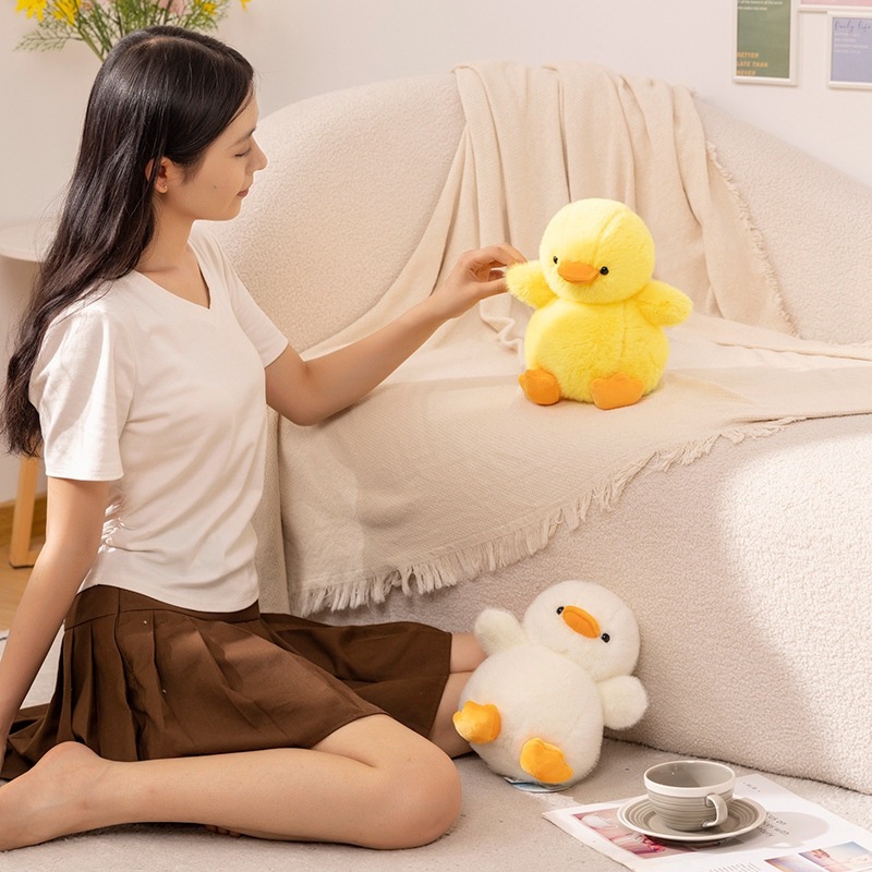 Duck plush toy displayed in a cozy living room setting, used for relaxing and decorative purposes, adding a warm and cute touch to sofa and floor spaces