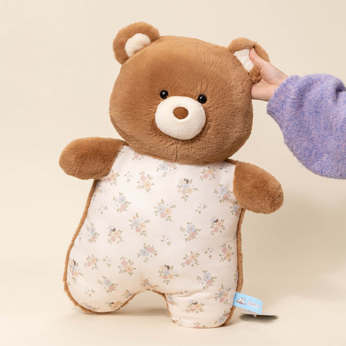 Brown bear pajama plush pillow shown in use, soft pillow for cuddling and relaxing on sofa or bed, warm and cozy comfort