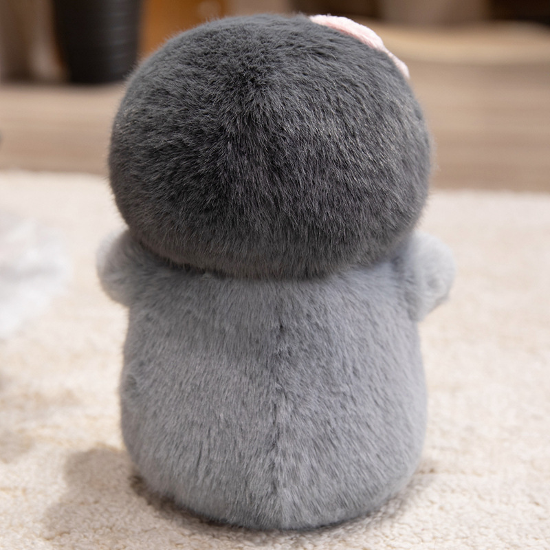 Back view of a bow penguin plush toy showing its smooth plush fabric, rounded body shape, and soft cushioning, designed for cuddling and decorative display