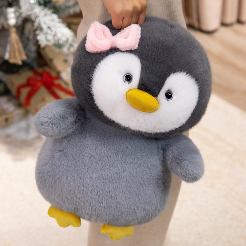 Bow penguin plush toy with soft fluffy texture and rounded body design