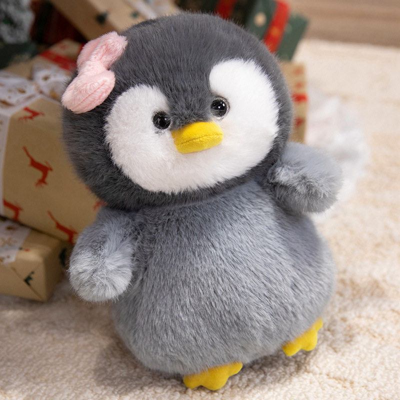 Bow penguin plush toy with soft plush fabric and cozy home setting