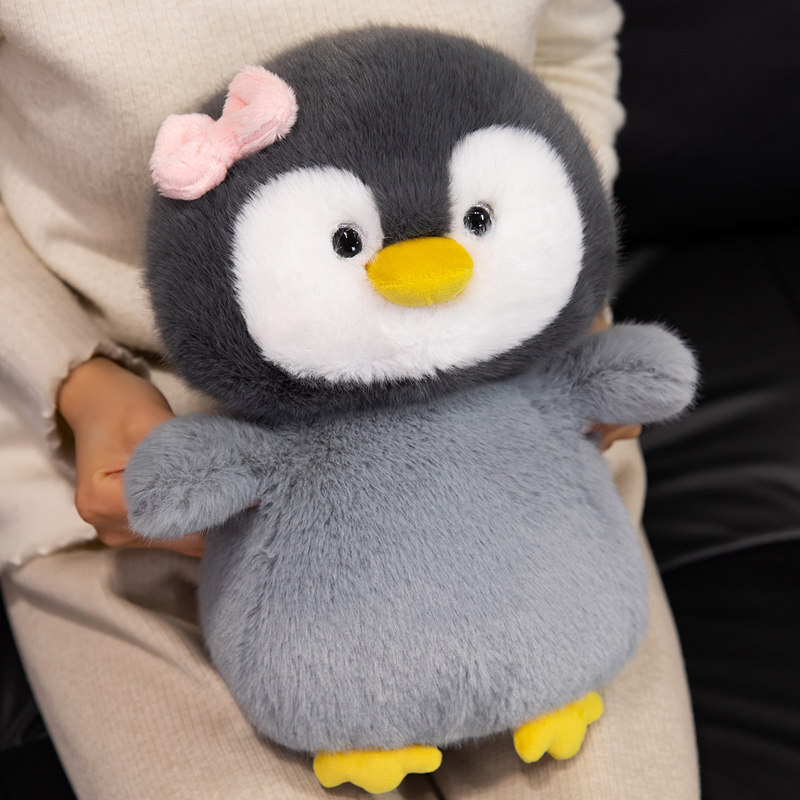 Bow penguin plush toy with soft plush fabric and rounded cuddly shape