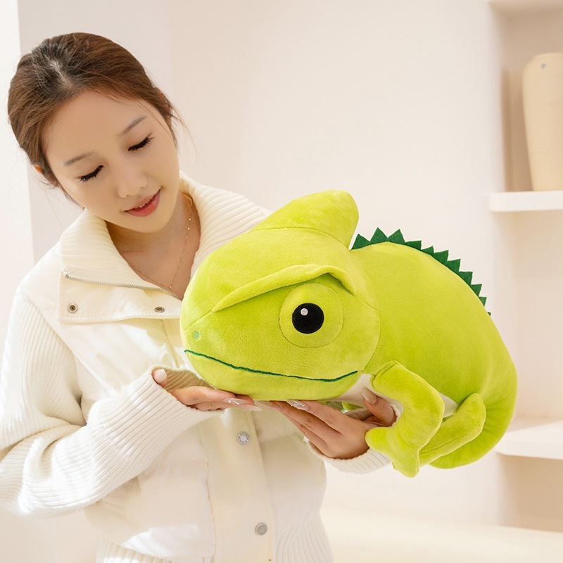 Green chameleon plush toy held and hugged, showing soft texture, rounded shape, and cozy size for cuddling and home decor