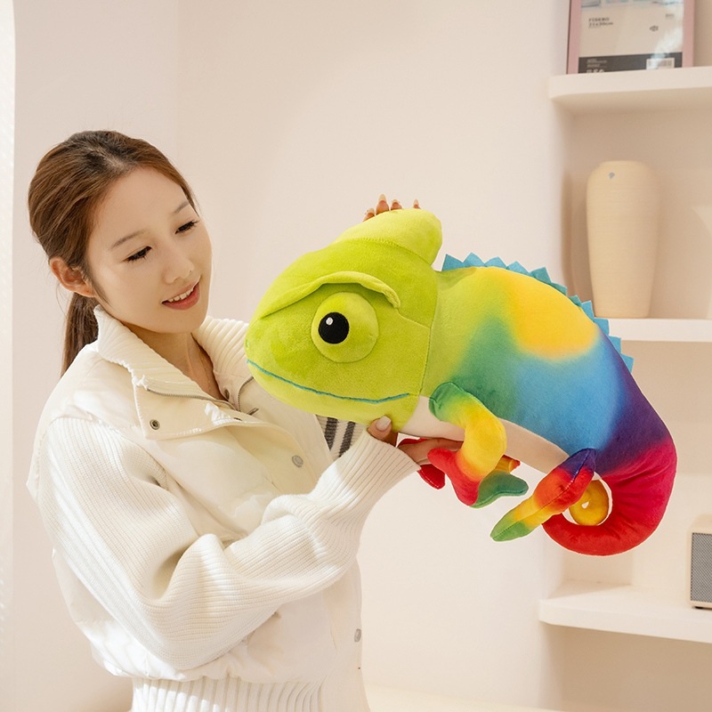 Rainbow gradient chameleon plush toy with curled tail, shown to illustrate size, comfort, and playful home decor use