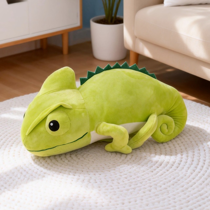 Green chameleon plush toy resting on a soft rug, showing a cozy lounging style and smooth plush texture, ideal as a decorative cushion or cuddly companion for home spaces