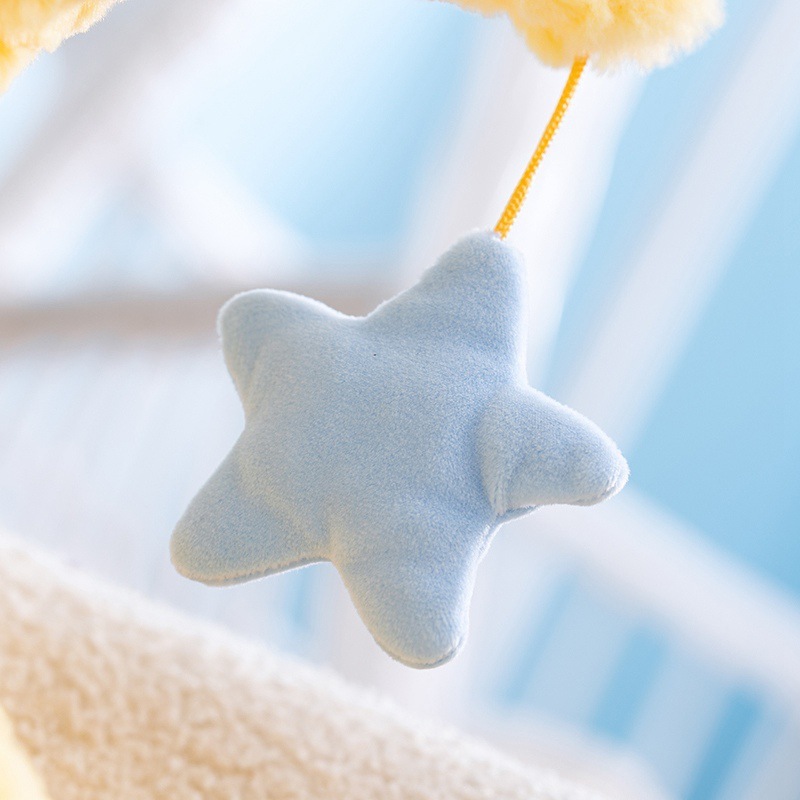 Moon plush pillow with hanging star detail made of soft plush fabric, adding a playful and soothing touch to cozy home decor, bedtime comfort, and relaxing spaces