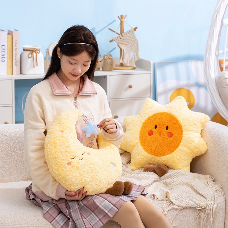 Healing sun and moon plush pillows displayed on a sofa, soft decorative cushions creating a warm and cozy home atmosphere