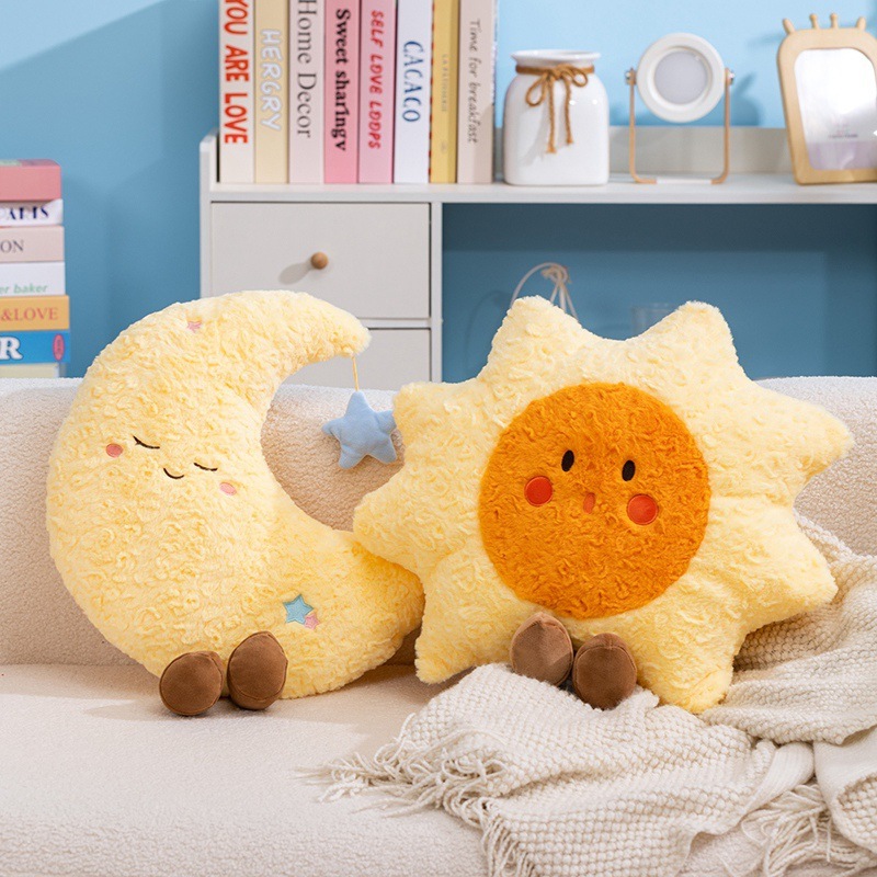 Healing sun and moon plush pillows placed on a sofa, soft decorative cushions creating a warm, cozy, and calming home atmosphere