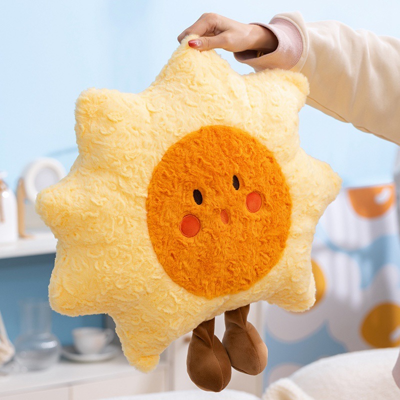 Sun plush pillow lifted to show its lightweight and fluffy texture, star-shaped cushion with soft plush fabric and a cheerful design, suitable for hugging, lounging, and decorative use