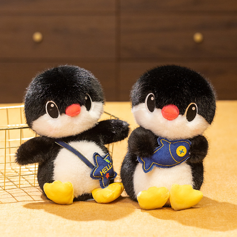 Penguin plush toys in fish and backpack styles displayed together