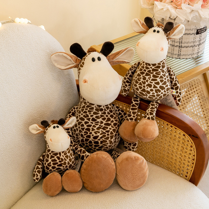 Giraffe plush toy in multiple sizes displayed on a sofa, soft stuffed animal for hugging, relaxing and cozy home decoration