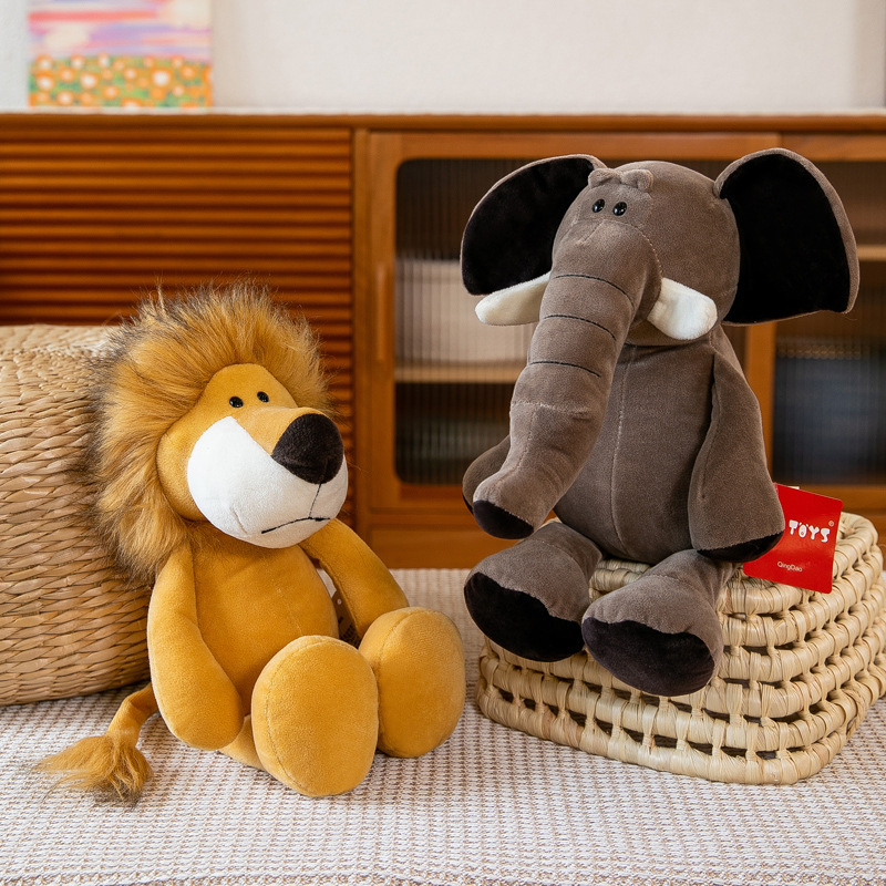 Lion and elephant plush toys displayed together on woven baskets in a cozy home setting