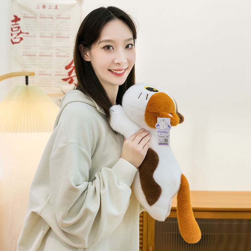 Soft lying calico cat plush toy resting against the shoulder, highlighting its cuddly shape, plush feel, and soothing presence for relaxation and comfort