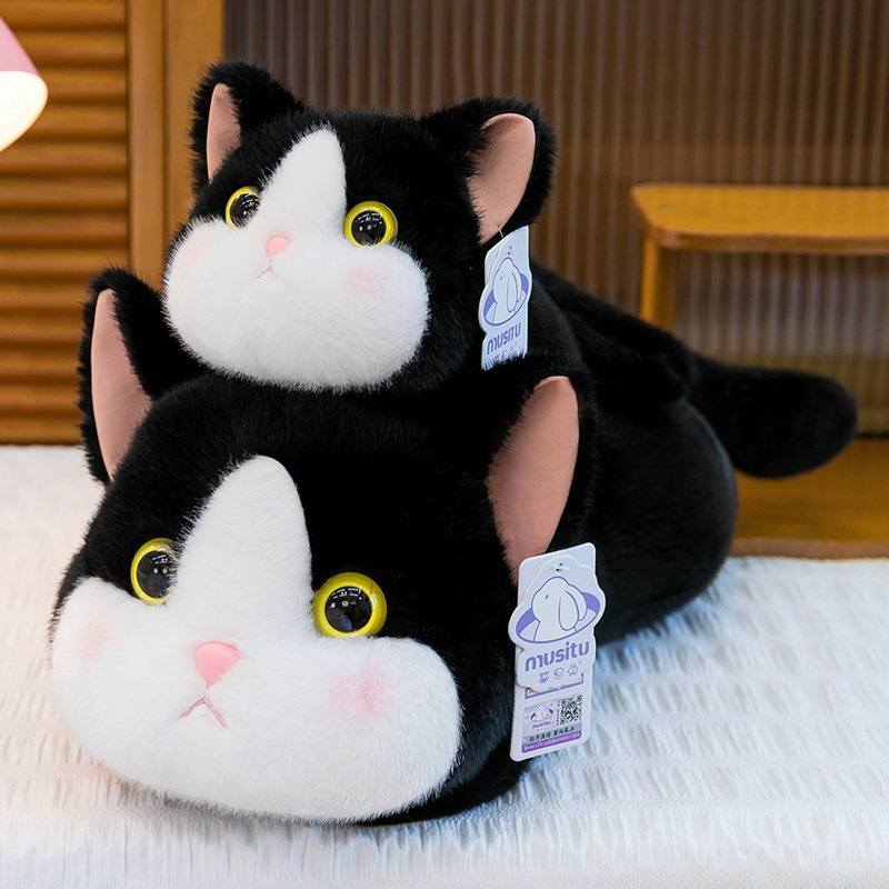 Soft lying cat plush toy in cow cat design with fluffy texture, shown in two sizes for hugging, relaxing, and cozy bedroom decor
