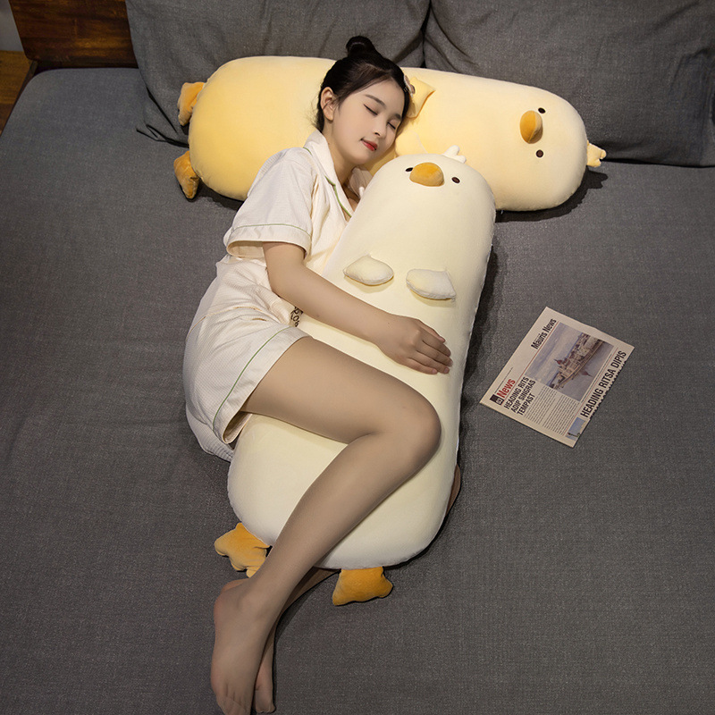 Milk chick plush pillow used as a long body pillow for sleeping, soft plush fabric with full PP cotton filling, designed for hugging and side sleeping on bed, cozy and calming bedroom atmosphere