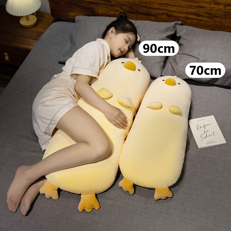 Milk chick plush pillow size comparison showing 70cm and 90cm long chicken body pillows on bed, soft plush fabric with full-body support, ideal for sleeping, hugging, and cozy nighttime comfort