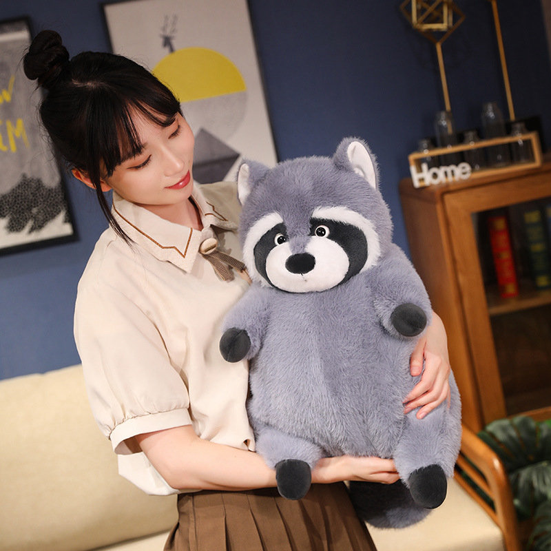 Chubby raccoon plush toy with round shape and ultra-soft texture, designed for hugging and relaxation, shown in a cozy living room setting to highlight comfort and cuddle-ready size