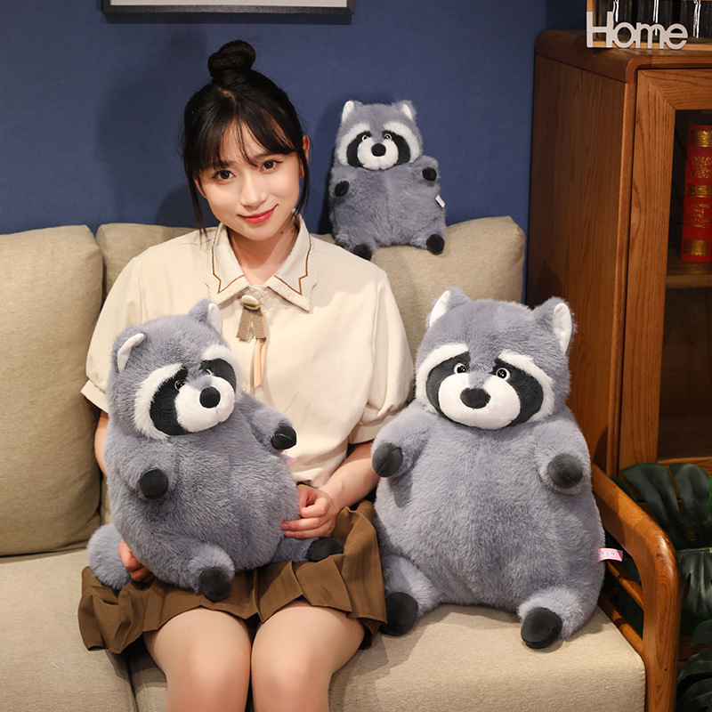 Chubby raccoon plush toys placed on a sofa in a cozy living room setting, showcasing fluffy texture, upright sitting design, and a comforting, warm atmosphere for home decor and relaxation