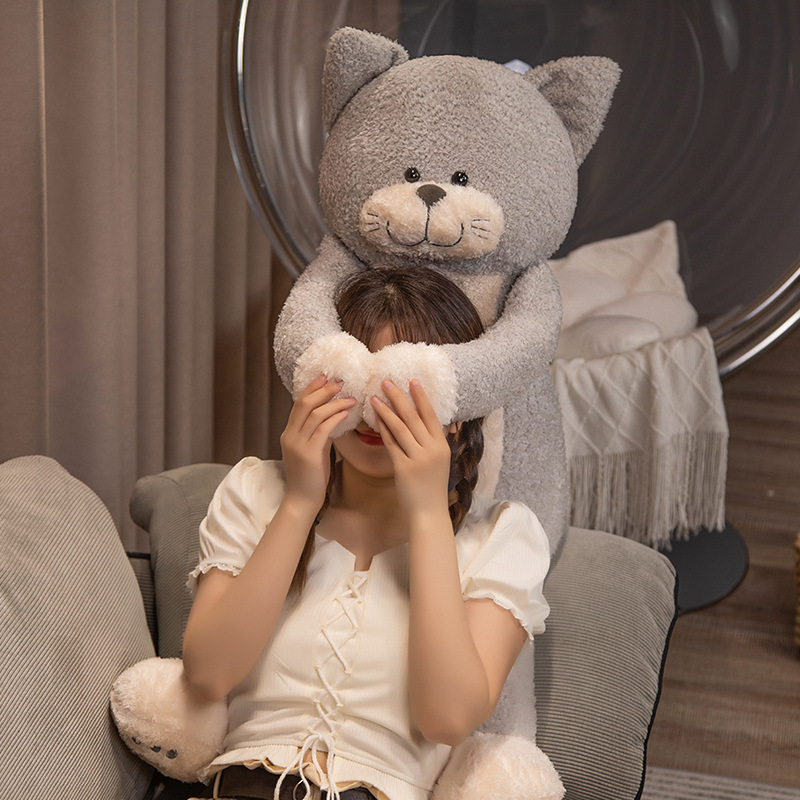 Gray jimmy cat plush toy with plush fabric and rounded design, shown in a comforting hug position, expressing warmth, softness, and emotional companionship, ideal for relaxing moments, bedtime comfort, or cozy home decor